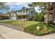 Charming two-story home featuring a brick facade, well-manicured lawn, and mature trees at 17595 E Wesley Pl, Aurora, CO 80013