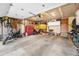 Spacious garage with ample storage space, tools, and room for parking vehicles and a motorcycle at 17595 E Wesley Pl, Aurora, CO 80013