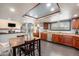 Bright kitchen featuring wood cabinets, a stainless steel dishwasher, and an adjacent dining area at 17595 E Wesley Pl, Aurora, CO 80013