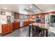 Traditional kitchen with wooden cabinetry, stainless steel appliances, and a dining table at 17595 E Wesley Pl, Aurora, CO 80013