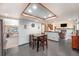 Cozy kitchen with wood cabinets, stainless steel refrigerator, and an open view to the living area at 17595 E Wesley Pl, Aurora, CO 80013
