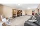 Open-concept living room with a staircase, neutral walls, and cozy seating area at 17595 E Wesley Pl, Aurora, CO 80013
