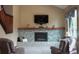 Inviting living room featuring a stone fireplace and neutral decor with a staircase on the side at 17595 E Wesley Pl, Aurora, CO 80013