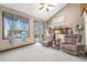 Inviting living room features vaulted ceilings, skylight, and seamless access to the outdoor patio at 17595 E Wesley Pl, Aurora, CO 80013