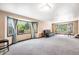 Spacious living room with large windows providing ample natural light and neutral carpeting at 17595 E Wesley Pl, Aurora, CO 80013