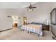 Spacious primary bedroom boasts neutral tones, a ceiling fan, and an ensuite bathroom at 17595 E Wesley Pl, Aurora, CO 80013