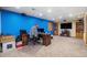 Finished basement office with a fireplace, carpeted floors, and a large wall-mounted television at 17595 E Wesley Pl, Aurora, CO 80013