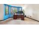 Sunlit home office with bay window, desk with multiple monitors, and plush carpeting at 17595 E Wesley Pl, Aurora, CO 80013