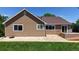 Charming house with a brown exterior, a patio and a beautiful green lawn at 1936 E 144Th Dr, Thornton, CO 80602