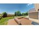 This backyard features a wooden deck and lush green lawn at 1936 E 144Th Dr, Thornton, CO 80602