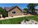 Charming home featuring a brown exterior, a concrete patio, and a beautifully landscaped yard at 1936 E 144Th Dr, Thornton, CO 80602