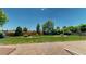 This backyard features a lush green lawn and wood fence at 1936 E 144Th Dr, Thornton, CO 80602
