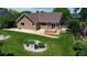 Lovely home with a brown exterior, patio, lush lawn, and rock garden at 1936 E 144Th Dr, Thornton, CO 80602