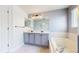 Bathroom featuring double vanity, tub, and tile floors at 1936 E 144Th Dr, Thornton, CO 80602