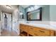 Bathroom featuring wood vanity, white counters, and tile flooring at 1936 E 144Th Dr, Thornton, CO 80602
