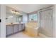 Bathroom featuring double vanity, tub, and glass door shower at 1936 E 144Th Dr, Thornton, CO 80602