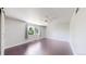 Bright bedroom with hardwood floors, shiplap wall, and natural light from large window at 1936 E 144Th Dr, Thornton, CO 80602
