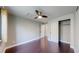 This bedroom features gray walls, wood flooring, a ceiling fan and a closet at 1936 E 144Th Dr, Thornton, CO 80602
