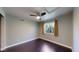 This bedroom features gray walls, wood flooring, a ceiling fan and a window at 1936 E 144Th Dr, Thornton, CO 80602