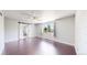 Bedroom featuring hardwood floors, barn door to bathroom, and large window at 1936 E 144Th Dr, Thornton, CO 80602