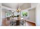 Elegant dining area with stylish chandelier and views of the living room at 1936 E 144Th Dr, Thornton, CO 80602