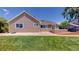 Exterior view of a home featuring a patio, deck, lush grass and landscaping at 1936 E 144Th Dr, Thornton, CO 80602