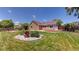 Exterior view of a home featuring lush grass and a garden at 1936 E 144Th Dr, Thornton, CO 80602