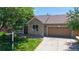 Charming single-Gathering home featuring a brick facade, attached garage, and well-manicured lawn at 1936 E 144Th Dr, Thornton, CO 80602