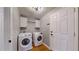 This laundry room features a side-by-side washer and dryer and overhead cabinets at 1936 E 144Th Dr, Thornton, CO 80602