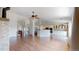 Open-concept living area with wood floors and seamless access to the modern kitchen at 1936 E 144Th Dr, Thornton, CO 80602