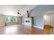 Open-concept living area with hardwood floors and a stylish fireplace feature at 1936 E 144Th Dr, Thornton, CO 80602