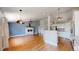 Bright living room with a cozy fireplace open to the kitchen area at 1936 E 144Th Dr, Thornton, CO 80602