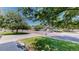 A street view showing green grass, trees, and other homes on the block at 1936 E 144Th Dr, Thornton, CO 80602