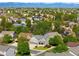 Aerial view of a neighborhood showcasing beautiful homes, lush greenery, and stunning mountain views at 10511 Jaguar Gln, Lone Tree, CO 80124