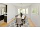 Elegant dining room with a modern chandelier, seating for eight, and a sunlit bay window at 10511 Jaguar Gln, Lone Tree, CO 80124