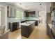 Contemporary kitchen with an island, dark cabinetry, modern appliances, and a view of the adjacent dining area at 10511 Jaguar Gln, Lone Tree, CO 80124