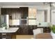 Contemporary kitchen with stainless steel appliances and dark cabinets, plus cozy eating area at 10511 Jaguar Gln, Lone Tree, CO 80124