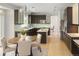 Modern kitchen with stainless steel appliances, dark cabinetry, center island, and an adjacent breakfast nook at 10511 Jaguar Gln, Lone Tree, CO 80124