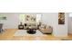 Bright living room with hardwood floors, neutral-toned sofas, stylish decor, and plenty of natural light at 10511 Jaguar Gln, Lone Tree, CO 80124