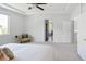 Spacious main bedroom with a ceiling fan, a neutral chair and an en-suite bathroom at 10511 Jaguar Gln, Lone Tree, CO 80124