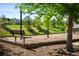 Neighborhood playground featuring swings, a bench, and mature trees in a lush, green setting at 10511 Jaguar Gln, Lone Tree, CO 80124