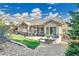 Beautiful home backyard with stone patio, lush lawn, and charming stone fire pit at 2885 W 115Th Dr, Denver, CO 80234