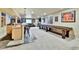 Spacious finished basement with a bar area, shuffleboard table, and plenty of room for entertaining guests at 2885 W 115Th Dr, Denver, CO 80234