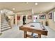 Basement area with a pool table, staircase and doorway at 2885 W 115Th Dr, Denver, CO 80234