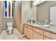Powder room with a modern vanity, decorative mirror, and a toilet at 2885 W 115Th Dr, Denver, CO 80234