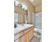 Well-lit bathroom features a modern vanity, tiled floors, and a shower with glass doors at 2885 W 115Th Dr, Denver, CO 80234