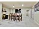 Dining area with wood table, chairs, and entertainment area with TV at 2885 W 115Th Dr, Denver, CO 80234