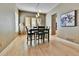 Bright dining room with hardwood floors, natural light, and contemporary light fixture at 2885 W 115Th Dr, Denver, CO 80234