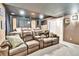 Home theater with tiered seating, projector, and dark walls for an immersive experience at 2885 W 115Th Dr, Denver, CO 80234