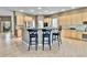 Well-lit kitchen with a breakfast bar, ample counter space, and natural wood cabinetry at 2885 W 115Th Dr, Denver, CO 80234